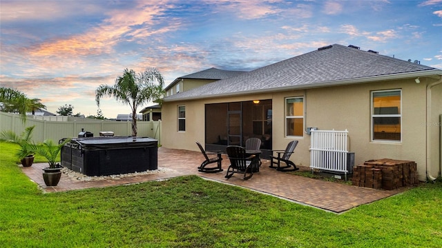 3336 Jackson Bluff Way, Clermont, FL 34711 - back of house featuring stucco siding, a shingled roof, a patio, and a hot tub