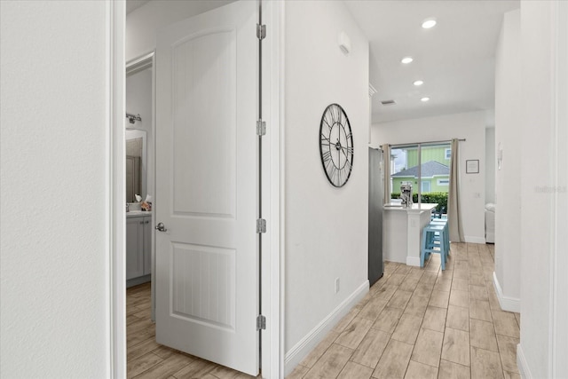 8017 Sandy Toes Way, Kissimmee, FL 34747 - corridor with light wood-style flooring and recessed lighting