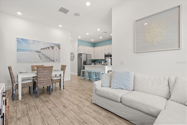 8017 Sandy Toes Way, Kissimmee, FL 34747 - living room with recessed lighting and light wood-type flooring