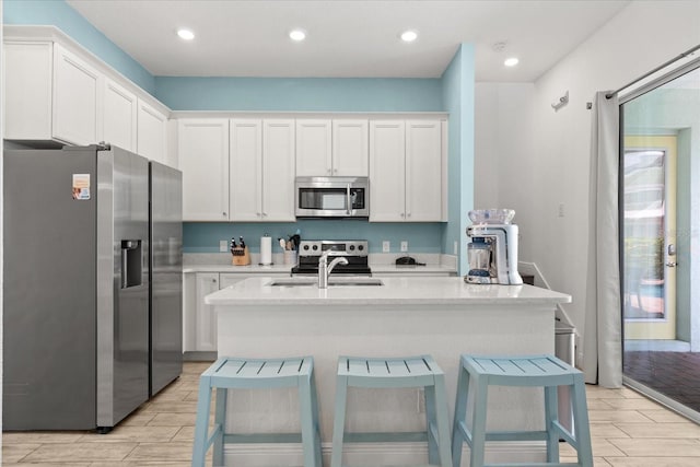 8017 Sandy Toes Way, Kissimmee, FL 34747 - kitchen with stainless steel appliances, wood tiled floors, light countertops, white cabinetry, and recessed lighting