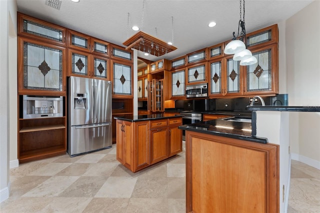 11031 Ledgement Ln, Windermere, FL 34786 - kitchen featuring appliances with stainless steel finishes, brown cabinetry, dark countertops, hanging light fixtures, and recessed lighting