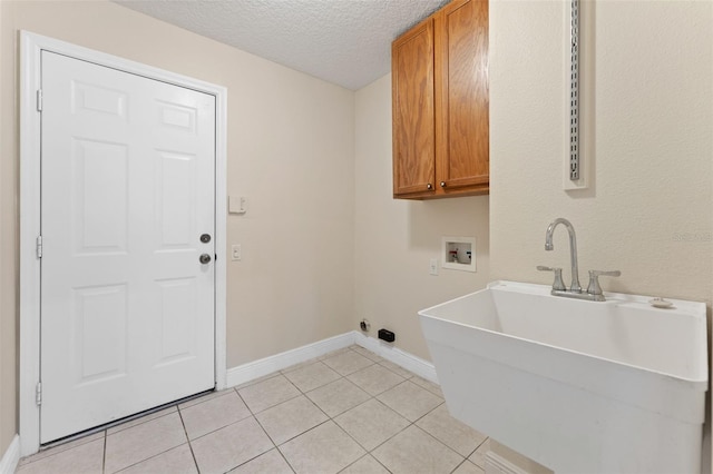 11031 Ledgement Ln, Windermere, FL 34786 - laundry room featuring cabinet space, washer hookup, a textured ceiling, and light tile patterned floors