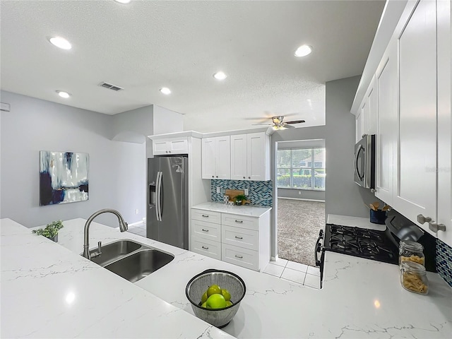 5754 Magnolia Bloom Ter, Oviedo, FL 32765 - kitchen with stainless steel appliances, recessed lighting, a ceiling fan, white cabinets, and light stone countertops