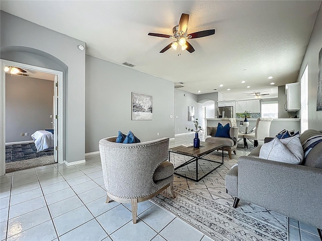 5754 Magnolia Bloom Ter, Oviedo, FL 32765 - living area with ceiling fan, light tile patterned floors, arched walkways, and recessed lighting
