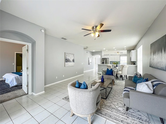 5754 Magnolia Bloom Ter, Oviedo, FL 32765 - living area featuring arched walkways, a ceiling fan, and light tile patterned flooring