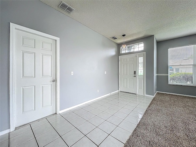 5754 Magnolia Bloom Ter, Oviedo, FL 32765 - foyer entrance featuring a textured ceiling and light tile patterned flooring