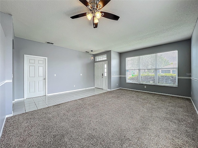 5754 Magnolia Bloom Ter, Oviedo, FL 32765 - spare room featuring carpet, a textured ceiling, a ceiling fan, and tile patterned floors