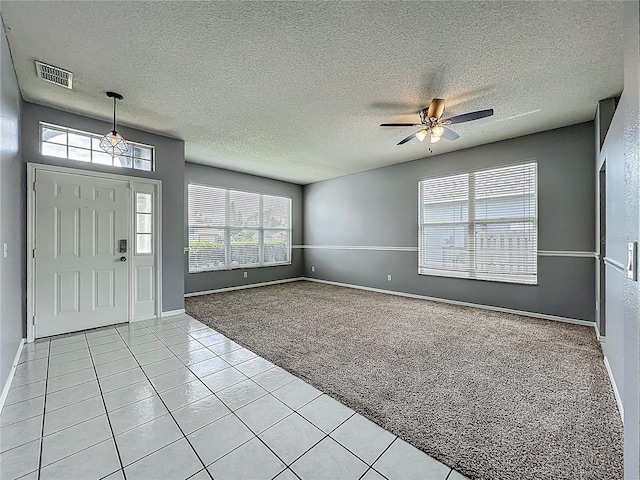 5754 Magnolia Bloom Ter, Oviedo, FL 32765 - foyer featuring light carpet, ceiling fan, light tile patterned floors, and a textured ceiling