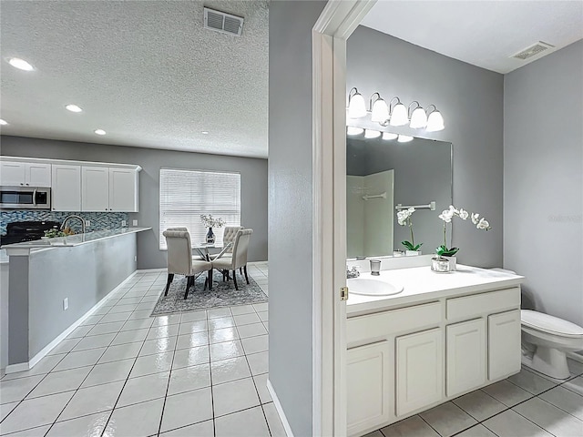 5754 Magnolia Bloom Ter, Oviedo, FL 32765 - full bath featuring tile patterned floors, vanity, recessed lighting, a textured ceiling, and tasteful backsplash