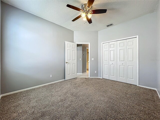 5754 Magnolia Bloom Ter, Oviedo, FL 32765 - unfurnished bedroom with light colored carpet, a textured ceiling, a closet, and ceiling fan