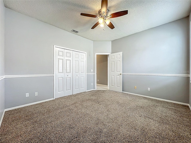 5754 Magnolia Bloom Ter, Oviedo, FL 32765 - unfurnished bedroom featuring a textured ceiling, carpet floors, a closet, and a ceiling fan