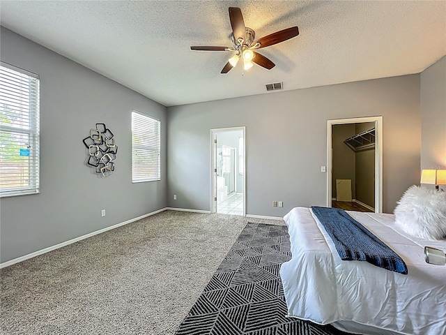 5754 Magnolia Bloom Ter, Oviedo, FL 32765 - carpeted bedroom featuring a textured ceiling, ensuite bathroom, and ceiling fan