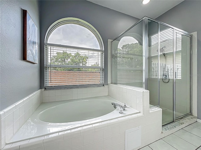 5754 Magnolia Bloom Ter, Oviedo, FL 32765 - bathroom with a garden tub, a stall shower, and tile patterned flooring