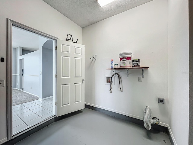 5754 Magnolia Bloom Ter, Oviedo, FL 32765 - laundry room with hookup for an electric dryer, hookup for a washing machine, a textured ceiling, and arched walkways