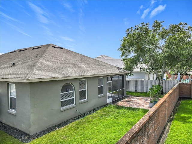 5754 Magnolia Bloom Ter, Oviedo, FL 32765 - back of house featuring a shingled roof, stucco siding, a patio, and a sunroom