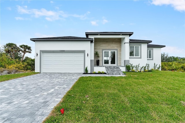 13438 Mcintosh Ave, Port Charlotte, FL 33981 - prairie-style house featuring stucco siding, a garage, decorative driveway, french doors, and a front yard