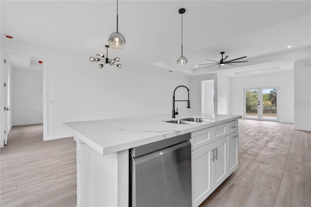 13438 Mcintosh Ave, Port Charlotte, FL 33981 - kitchen featuring stainless steel dishwasher, white cabinetry, open floor plan, decorative light fixtures, and french doors
