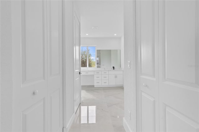 13438 Mcintosh Ave, Port Charlotte, FL 33981 - hall featuring light marble finish floors and recessed lighting