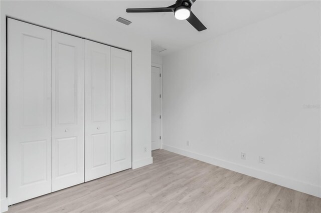 13438 Mcintosh Ave, Port Charlotte, FL 33981 - unfurnished bedroom featuring a closet, light wood-style flooring, and ceiling fan