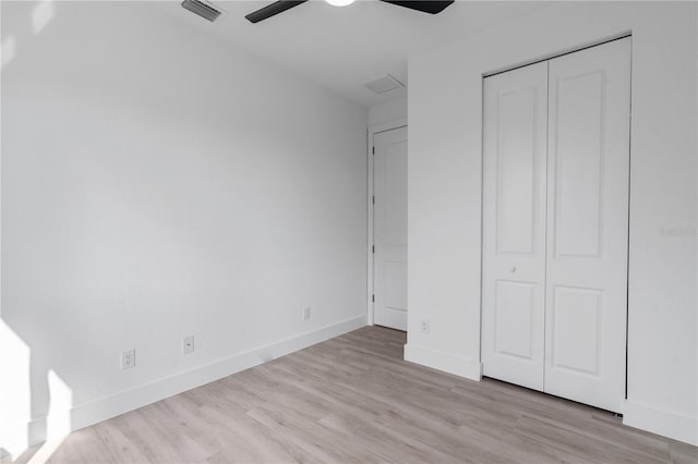 13438 Mcintosh Ave, Port Charlotte, FL 33981 - unfurnished bedroom with wood finished floors, a closet, and a ceiling fan