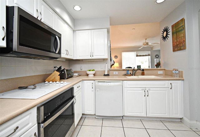 4624 Harbour Village Blvd Unit 4206, Ponce Inlet, FL 32127 - kitchen featuring white appliances, backsplash, light tile patterned flooring, light countertops, and white cabinetry