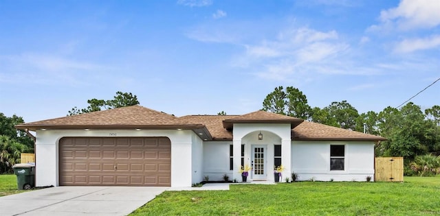 7450 Franzino Ave, North Port, FL 34291 - view of front of home with stucco siding, an attached garage, driveway, a front lawn, and a shingled roof