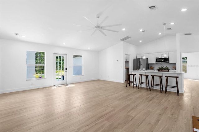 7450 Franzino Ave, North Port, FL 34291 - living room with a ceiling fan, light wood-style flooring, recessed lighting, and lofted ceiling