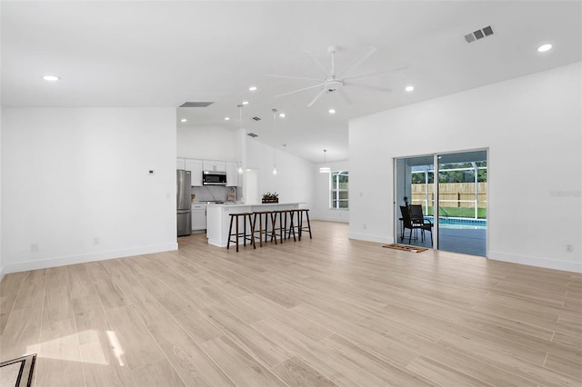 7450 Franzino Ave, North Port, FL 34291 - living area featuring a ceiling fan, recessed lighting, high vaulted ceiling, and light wood-style flooring