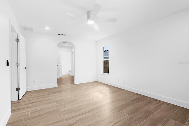 7450 Franzino Ave, North Port, FL 34291 - empty room with a ceiling fan, arched walkways, light wood finished floors, and recessed lighting