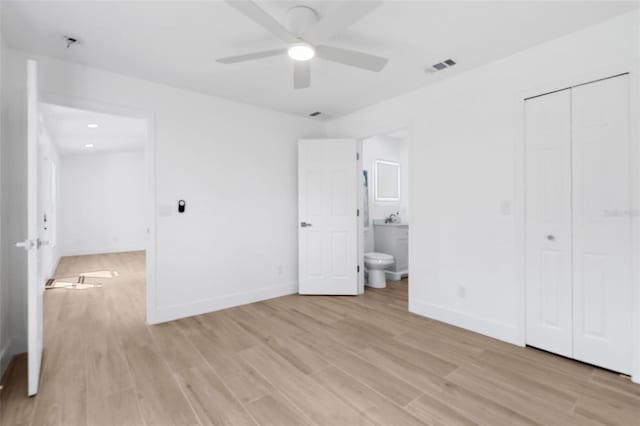 7450 Franzino Ave, North Port, FL 34291 - unfurnished bedroom with light wood-style flooring, connected bathroom, a closet, a ceiling fan, and recessed lighting