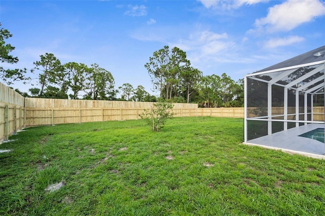 7450 Franzino Ave, North Port, FL 34291 - fenced backyard with glass enclosure and a patio
