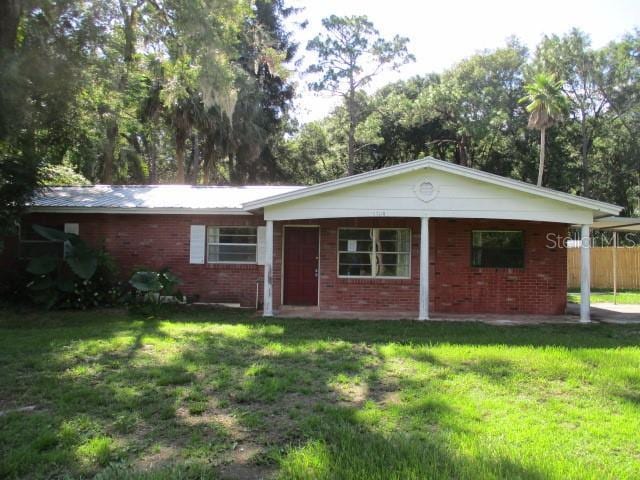 5304 Galloway Rd, Apopka, FL 32712 - ranch-style home featuring a front lawn, brick siding, and a carport