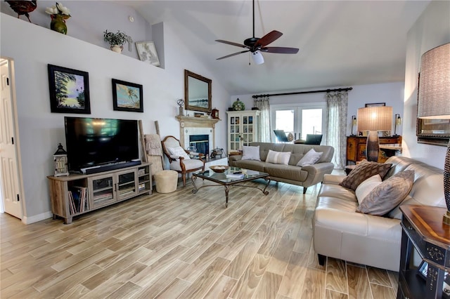 1624 Bear Crossing Cir, Apopka, FL 32703 - living room with ceiling fan, light wood-style floors, a glass covered fireplace, and high vaulted ceiling