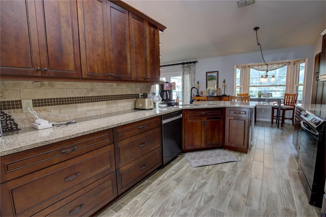 1624 Bear Crossing Cir, Apopka, FL 32703 - kitchen with electric range, dishwasher, a peninsula, and backsplash