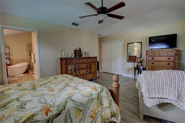 1624 Bear Crossing Cir, Apopka, FL 32703 - bedroom featuring a closet, wood finished floors, connected bathroom, and a ceiling fan