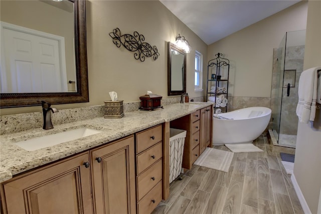 1624 Bear Crossing Cir, Apopka, FL 32703 - full bathroom with double vanity, a soaking tub, a stall shower, and vaulted ceiling