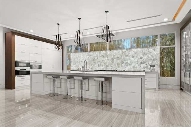 12264 Montalcino Cir, Windermere, FL 34786 - kitchen featuring modern cabinets, stainless steel oven, white cabinets, a chandelier, and recessed lighting