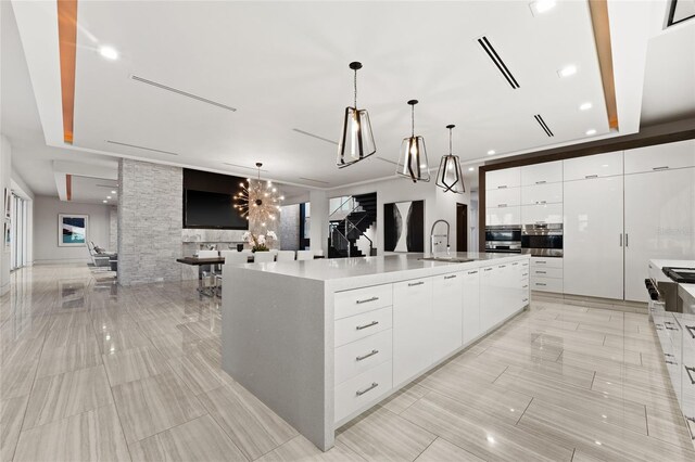 12264 Montalcino Cir, Windermere, FL 34786 - kitchen with modern cabinets, stainless steel oven, white cabinets, open floor plan, and recessed lighting