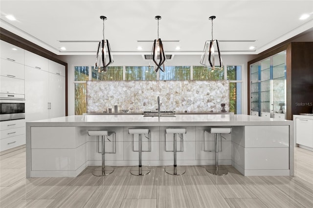 12264 Montalcino Cir, Windermere, FL 34786 - kitchen featuring oven, modern cabinets, white cabinets, light countertops, and recessed lighting