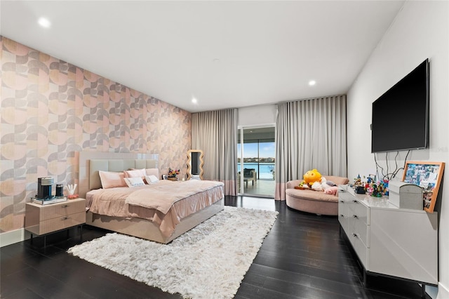 12264 Montalcino Cir, Windermere, FL 34786 - bedroom featuring dark wood-type flooring, recessed lighting, an accent wall, and access to exterior
