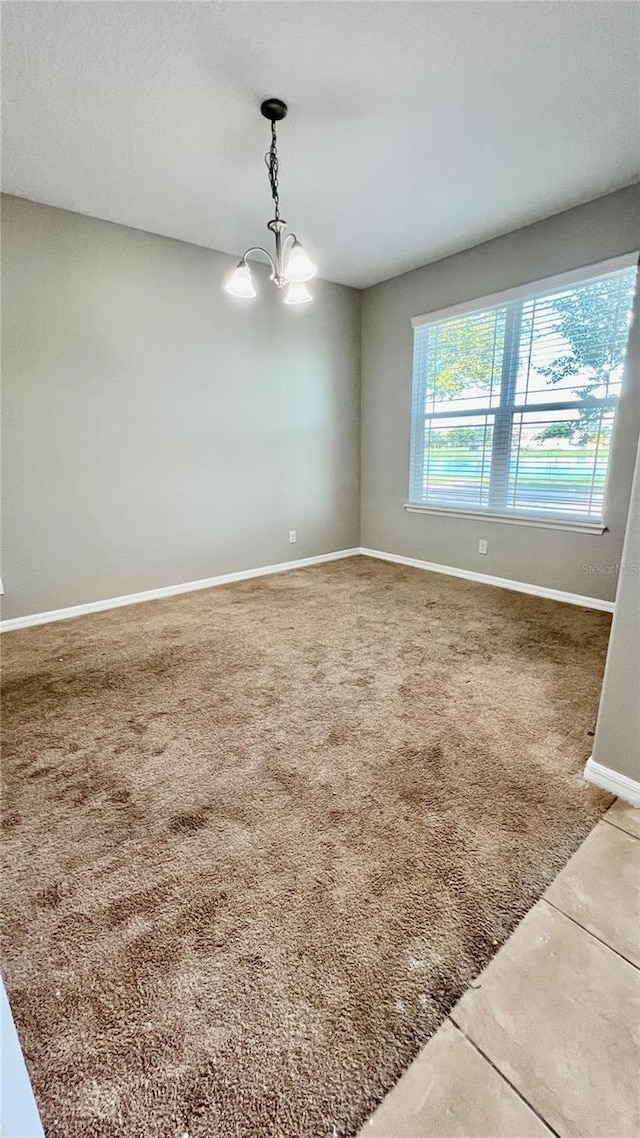 8625 Coventry Park Way, Windermere, FL 34786 - carpeted empty room featuring a chandelier and tile patterned floors