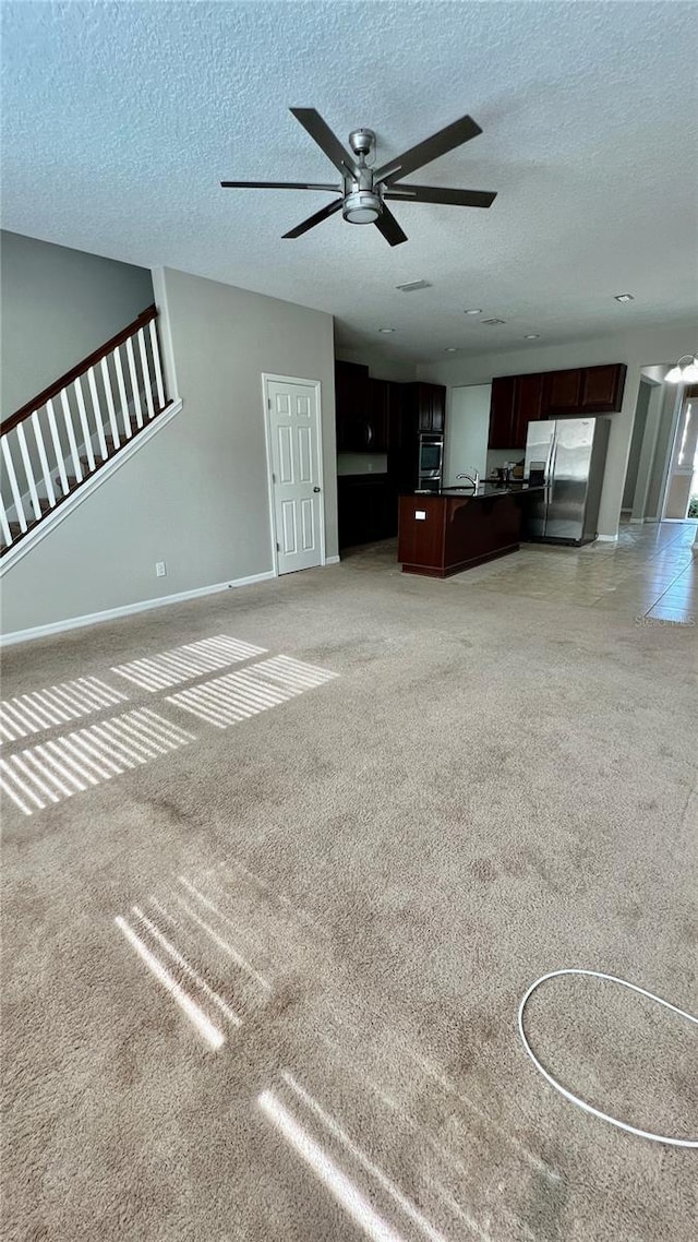 8625 Coventry Park Way, Windermere, FL 34786 - unfurnished living room featuring a ceiling fan, light carpet, and a textured ceiling