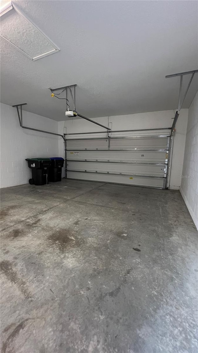 8625 Coventry Park Way, Windermere, FL 34786 - garage featuring a garage door opener and concrete block wall