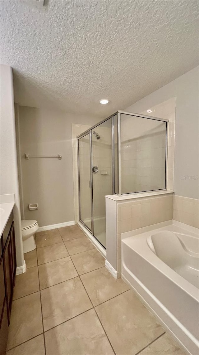 8625 Coventry Park Way, Windermere, FL 34786 - bathroom featuring tile patterned floors, a garden tub, vanity, a textured ceiling, and a shower stall