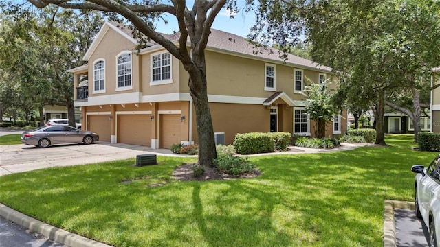 962 Ashworth Overlook Dr Unit C, Apopka, FL 32712 - view of front of home with stucco siding, a garage, concrete driveway, and a front lawn