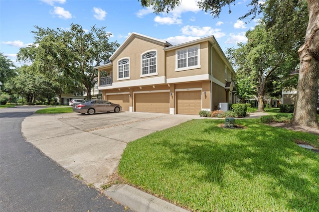 962 Ashworth Overlook Dr Unit C, Apopka, FL 32712 - view of front of house with concrete driveway, a front lawn, a garage, and stucco siding