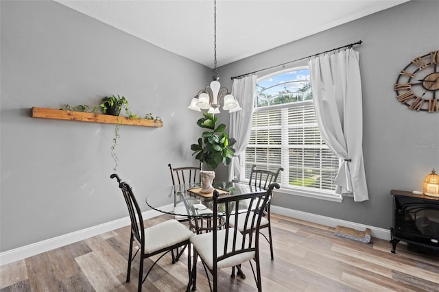 962 Ashworth Overlook Dr Unit C, Apopka, FL 32712 - dining area featuring a chandelier, plenty of natural light, wood finished floors, and a wood stove