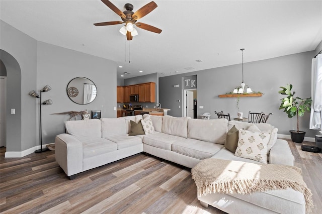 962 Ashworth Overlook Dr Unit C, Apopka, FL 32712 - living room with arched walkways, ceiling fan, and wood finished floors