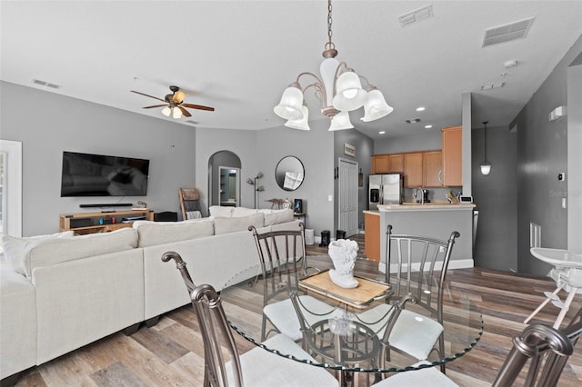 962 Ashworth Overlook Dr Unit C, Apopka, FL 32712 - dining space featuring wood finished floors, arched walkways, ceiling fan, and a chandelier