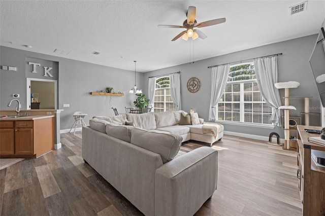 962 Ashworth Overlook Dr Unit C, Apopka, FL 32712 - living room with a ceiling fan, wood finished floors, and a textured ceiling